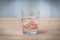 False teeth swim in transparent water glass