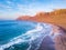 Famara Atlantic ocean beach surf spot aerial view  of scenic landscape from drone in Lanzarote, Canary islands during warm sunny