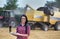 Famer girl with laptop in the field during harvest