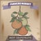 Famer market label with grapefruit branch color sketch on wooden background.