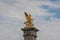 `Fames`, gilt-bronze statues of Fames over the Pont Alexandre III deck arch bridge