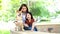 Families with mothers and daughters playing with Shiba Inu dogs in the park in spring