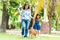 Families with mothers and daughters walking with Shiba Inu dogs in the park in spring