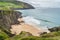 Families relaxing on Coumeenoole Beach hidden between cliffs in Dingle