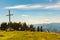 Families and tourists at the Schockl mountain next to the cross at the peak. Tourist destination