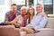 Family With Adult Children Relaxing On Sofa At Home Together