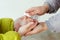 Family applying hand sanitizer to clean and disinfect hands. People disinfecting hands with antiseptic spray