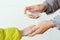 Family applying hand sanitizer to clean and disinfect hands. Woman applying alcohol spray against coronavirus