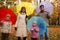 Family in autumn park with coloured umbrellas