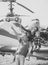 Family in the aviation museum. Mother, father and excited child sit on planes wing in aviation museum. Happy family