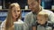 Family with baby son choosing household appliances in the store