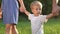 Family with baby a son walking in the park. Happy family walking in the park in nature relaxing outdoors. Happy family