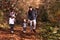 Family with baby and toddler hiking in the woods