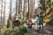 Family with backpacks hiking in a mountains actively spending summer vacation together