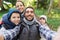 Family with backpacks taking selfie and hiking