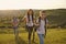 Family with backpacks on tourist trip in mountains. Cute girl with parents camping in wilderness during summer vacation