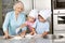 Family baking christmas cookies in kitchen