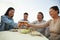 Family barbeque party, toasting at the table and smiling