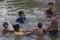 Family bathing in the river