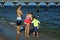 Family on the beach in front of a pier in Fort Lauderdale