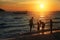 Family on the beach at sunset