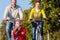 Family on bicycle tour in park