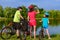 Family bike ride outdoors, active parents and kid cycling