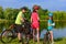 Family bike ride outdoors, active parents and kid cycling