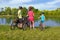 Family bike ride outdoors, active parents and kid cycling and relaxing outdoors near beautiful river, family sport