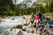 Family bike rides in the mountains while relaxing on the riverbank.