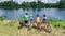 Family on bikes cycling outdoors, active parents and kids on bicycles, aerial view of happy family with children relaxing