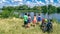 Family on bikes cycling outdoors, active parents and kids on bicycles, aerial view of happy family with children relaxing