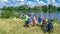 Family on bikes cycling outdoors, active parents and kids on bicycles, aerial view of happy family with children relaxing