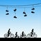 Family on bikes under shoes on wires