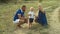 Family blowing soap bubbles in forest