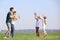 Family blowing soap bubbles near river on summer day