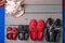 Family boat shoes on wooden background. Four pair of red and black grey desk with rope shell. Top view, copy space