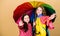 Family bonds. Little girls in raincoat. happy little girls with colorful umbrella. rain protection. Rainbow. autumn