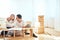 Family with boy assembling furniture at home, mother and son hugging after finishing assemble