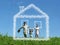 Family with boy on meadow and dream cloud house