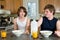 Family breakfast fun - teen brothers having cereal: candid shots