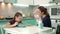 Family breakfast at morning. Girl eating corn flakes with milk at kitchen table