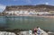 Family on the breakwater overlooking the bay at Puerto de Mogan on Gran Canaria.