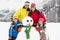 Family Building Snowman On Ski Holiday