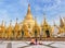 Family burmese people praying respects at Shwedagon big golden pagoda in rangoon, MyanmarBurma