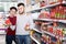 Family buying tinned food at supermarket