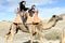 family camel ride in the beautiful landscapes of the desert