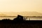 Family and camper van next to the beach at sunset. Empty copy space