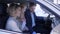 Family in car dealership, happy husband and wife with child considering new automobile while sitting in cabin at auto