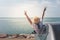 Family car trip at the sea, Portrait woman cheerful raising her hands up and feeling happiness.